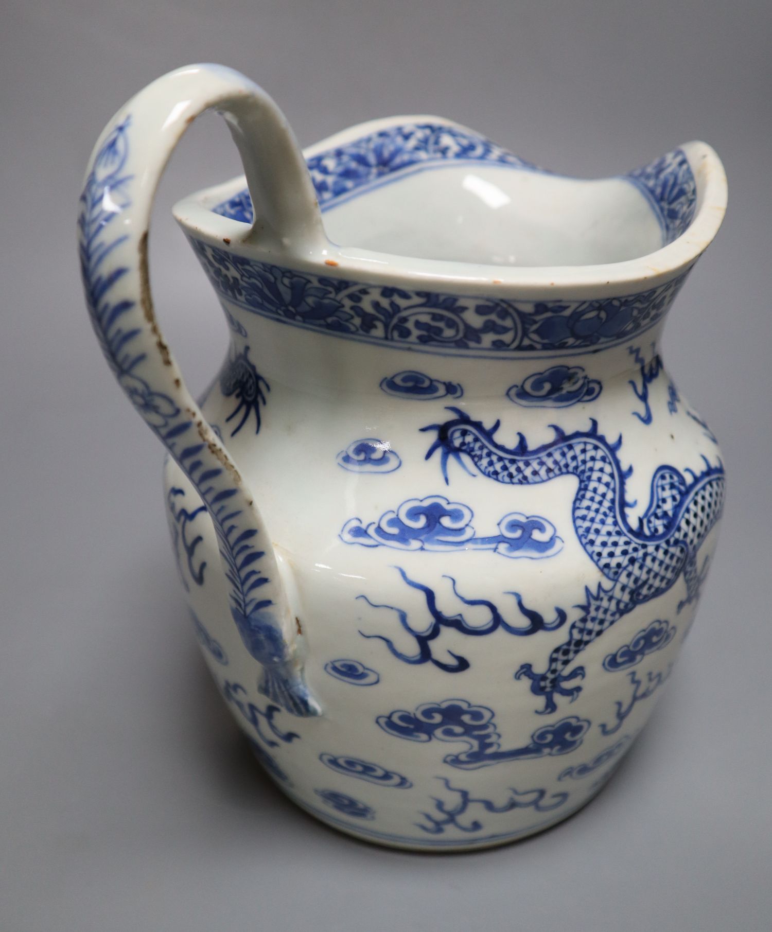 A 19th century Chinese blue and white dragon jug, 22cm